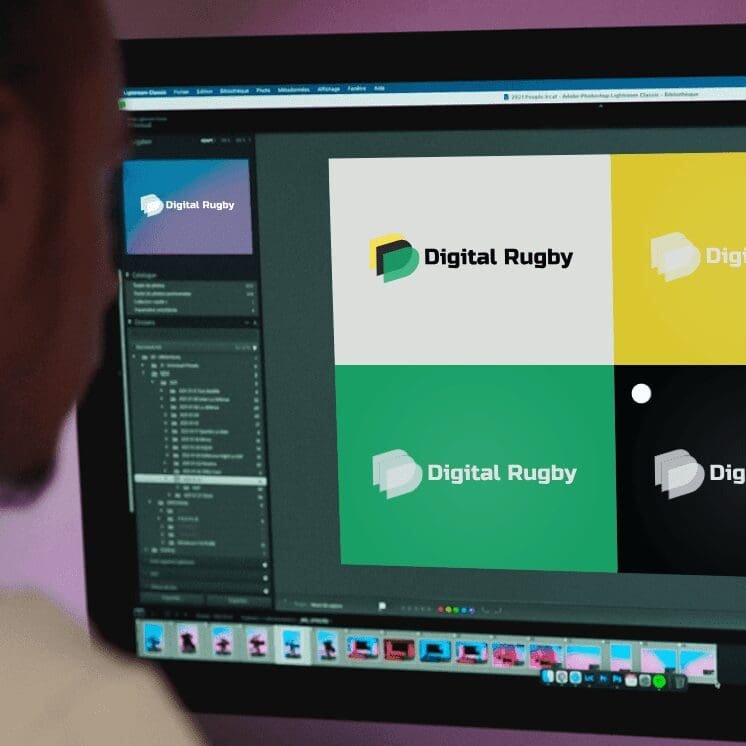 Designer reviewing Digital Rugby brand logo variations on a computer screen in a creative workspace